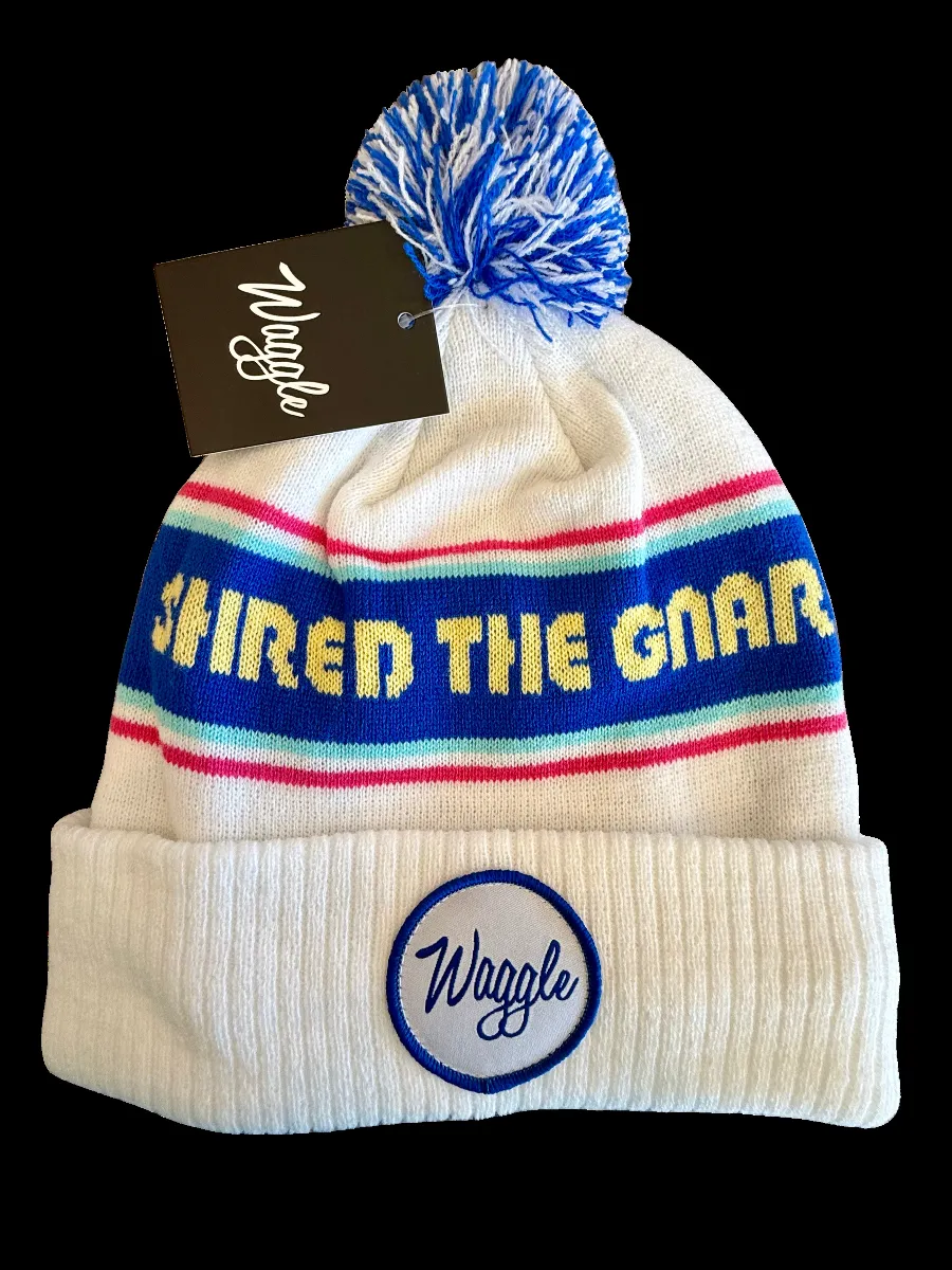 Waggle Beanie Blue, white, red Waggle pom pom beanie that says Shred the Gnar